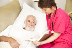 Nurse checking her elder male patient